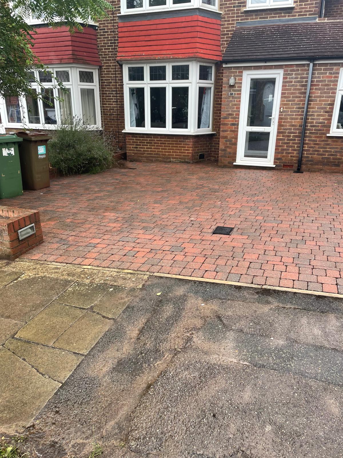 Red block paving driveway after pressure washing